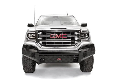 Fab Fours Black Steel front bumper on a white GMC Sierra 1500, straight-on front view, showing the diamond-plate bumper face, wrapped end caps and center shackle mount