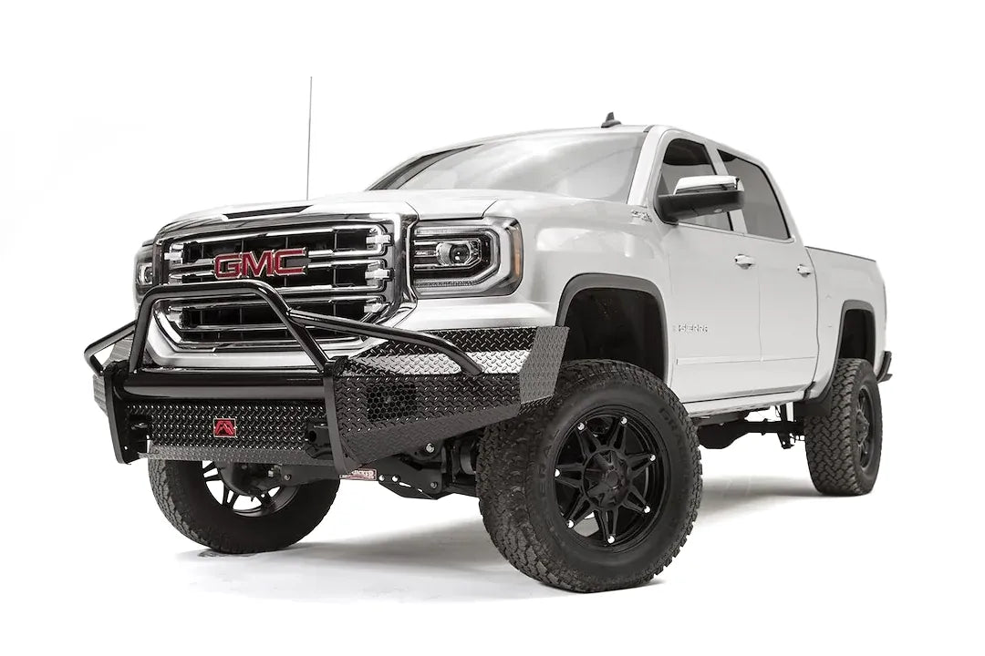 Fab Fours Black Steel front bumper with pre-runner guard on a white GMC Sierra 1500, driver-side front three-quarter view, showing the pre-runner hoop, diamond-plate bumper face and wrapped end caps