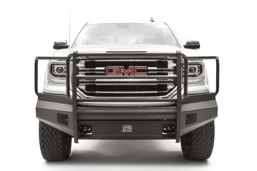 Fab Fours Black Steel Elite front bumper with full guard on a white GMC Sierra 1500, straight-on front view, showing the full grille guard with headlight hoops, smooth plate bumper face and mesh vent openings