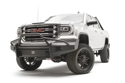 Fab Fours Black Steel Elite front bumper with pre-runner guard on a white GMC Sierra 1500, driver-side front three-quarter view, showing the pre-runner hoop, smooth plate bumper face and mesh vent openings