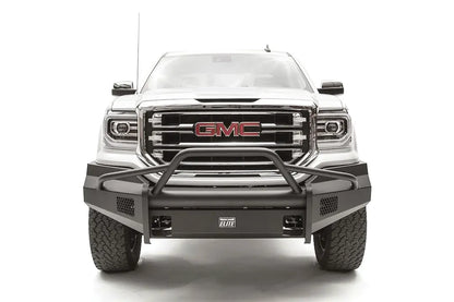 Fab Fours Black Steel Elite front bumper with pre-runner guard on a white GMC Sierra 1500, straight-on front view, showing the pre-runner hoop, smooth plate bumper face and mesh vent openings