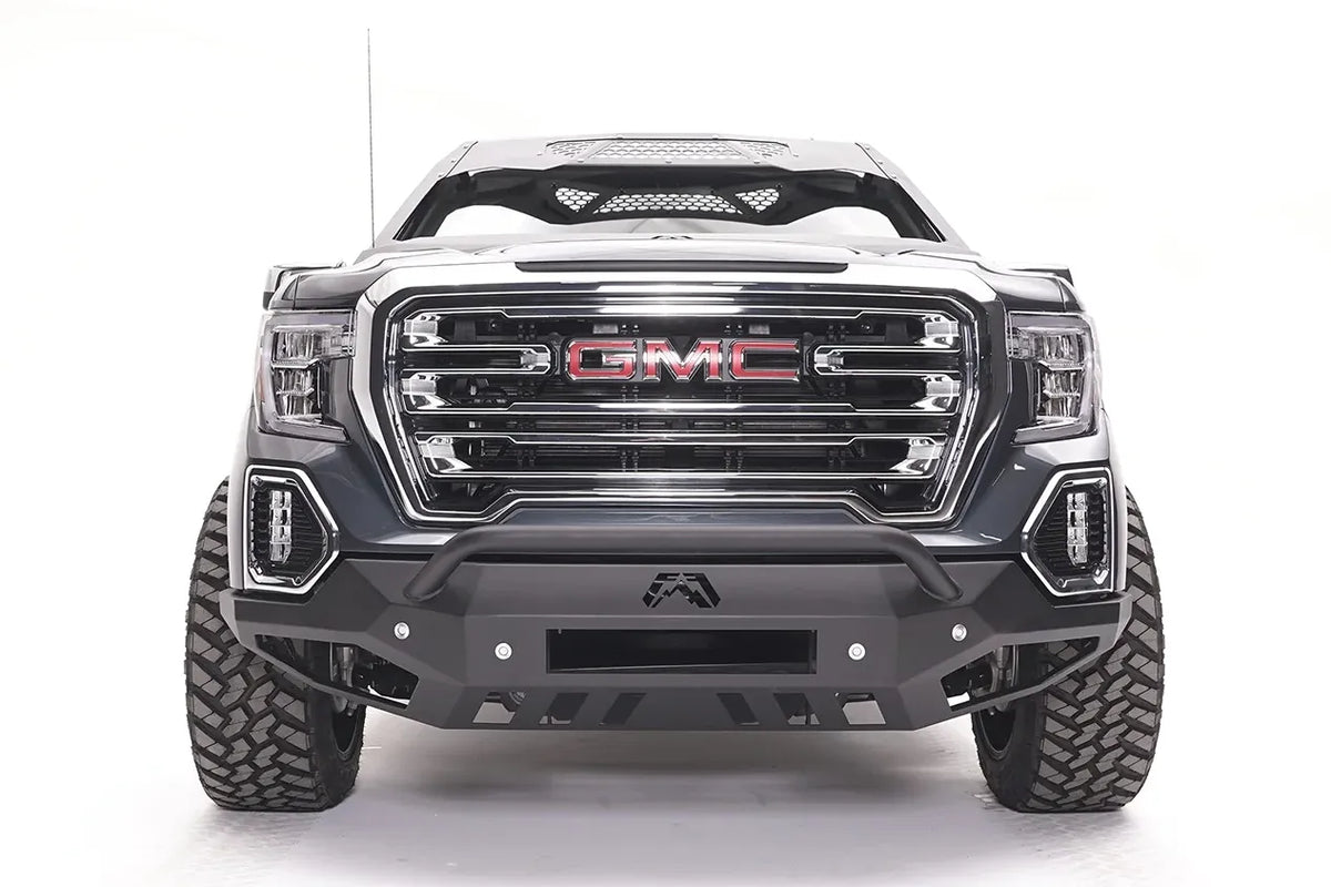 Fab Fours Vengeance front bumper with pre-runner guard on a dark gray GMC Sierra 1500, straight-on front view, showing the low pre-runner bar, center light bar opening and lower skid plate
