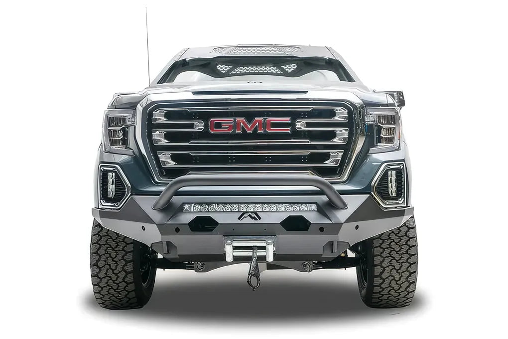 Fab Fours Matrix front bumper with pre-runner guard on a dark gray GMC Sierra 1500, straight-on front view, showing the pre-runner bar, light bar opening and winch fairlead