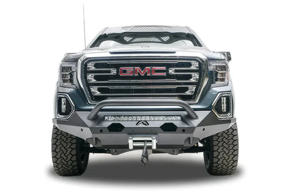 Fab Fours Matrix front bumper with pre-runner guard on a dark gray GMC Sierra 1500, straight-on front view, showing the pre-runner bar, light bar opening and winch fairlead