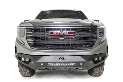 Fab Fours Vengeance front bumper on a silver GMC Sierra 1500, straight-on front view, showing the angular bumper face, corner pod lights and center light bar