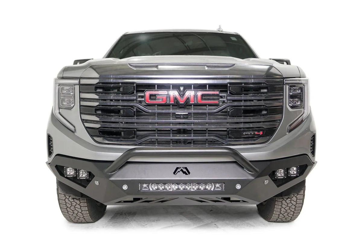 Fab Fours Vengeance front bumper with pre-runner guard on a silver GMC Sierra 1500, straight-on front view, showing the low pre-runner bar, corner pod lights and center light bar