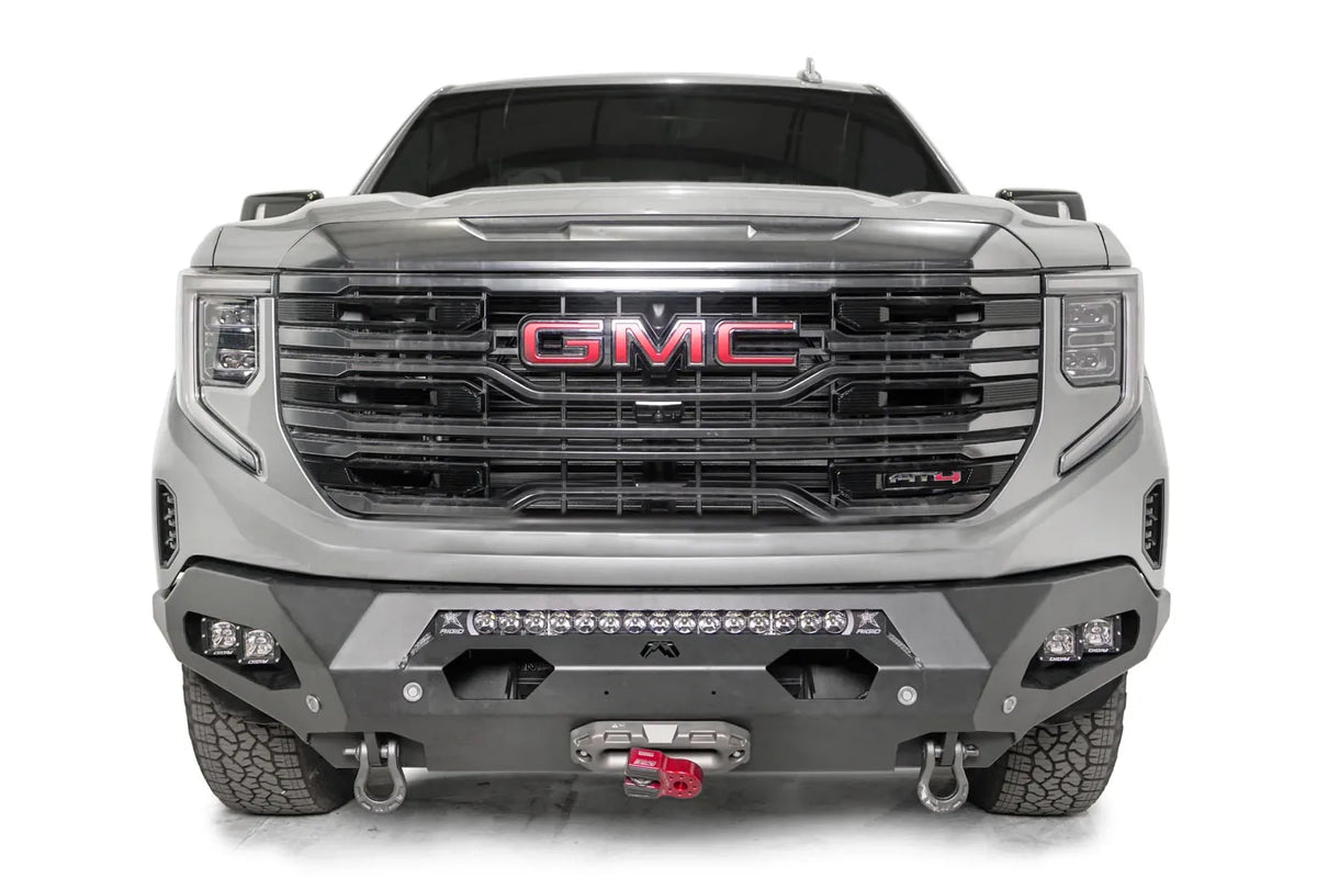 Fab Fours Matrix front bumper on a silver GMC Sierra 1500, straight-on front view, showing the center light bar, winch fairlead and D-ring shackle mounts