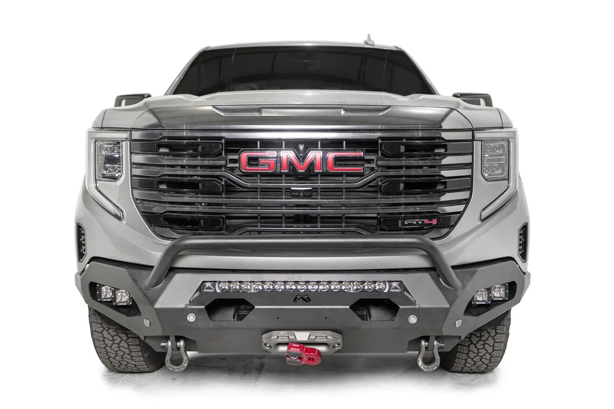 Fab Fours Matrix front bumper with pre-runner guard on a silver GMC Sierra 1500, straight-on front view, showing the pre-runner bar, center light bar and winch fairlead