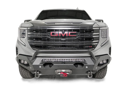 Fab Fours Matrix front bumper with pre-runner guard on a silver GMC Sierra 1500, straight-on front view, showing the pre-runner bar, center light bar and winch fairlead