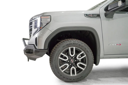 Fab Fours Matrix front bumper with pre-runner guard on a silver GMC Sierra 1500, close-up of the driver-side front corner, showing the pre-runner bar end, bumper end cap and wheel clearance