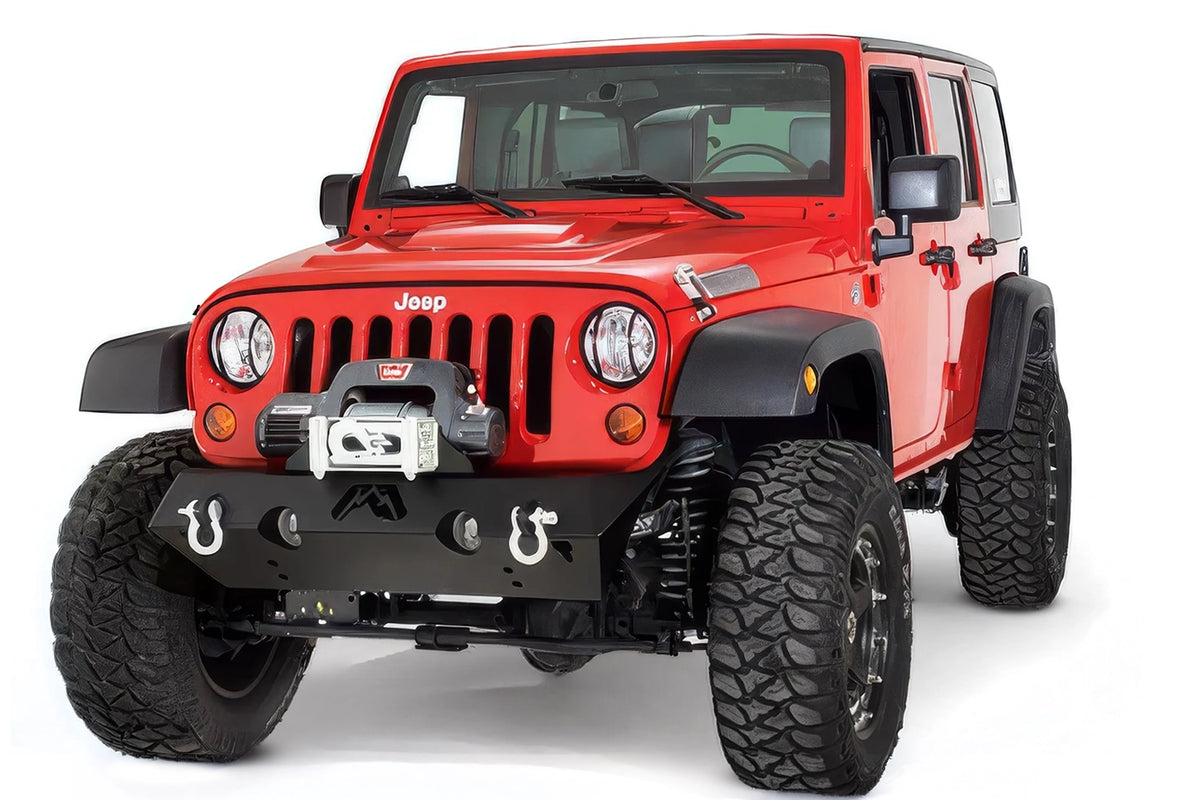 Fab Fours Hardcore Stubby Winch bumper on a red Jeep Wrangler JK, front three-quarter studio view, showing the stubby bumper, winch mount and D-ring shackles