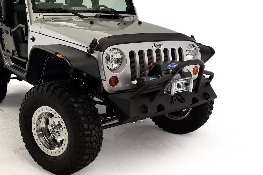 Fab Fours Hardcore Stubby Winch bumper with pre-runner guard on a silver Jeep Wrangler JK, close-up of the front, showing the pre-runner hoop, winch mount and stubby end caps