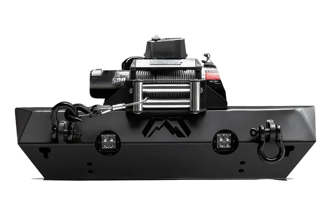 Fab Fours Stubby bumper in black powder coat, front view, showing the winch plate with winch installed, cube light cutouts and D-ring shackles