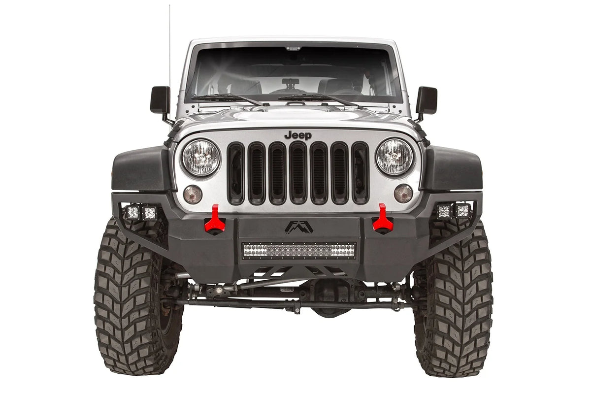 Fab Fours Vengeance front bumper on a silver Jeep Wrangler JK Rubicon, straight-on front view, showing the center light bar, corner pod lights and red shackles