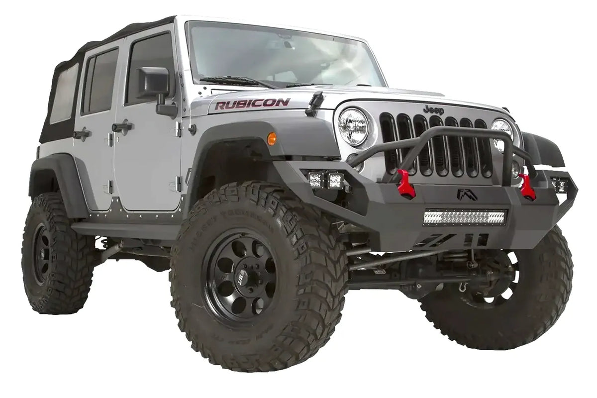 Fab Fours Vengeance front bumper with pre-runner guard on a silver Jeep Wrangler JK Rubicon, passenger-side front three-quarter view, showing the pre-runner hoop, center light bar and red shackles