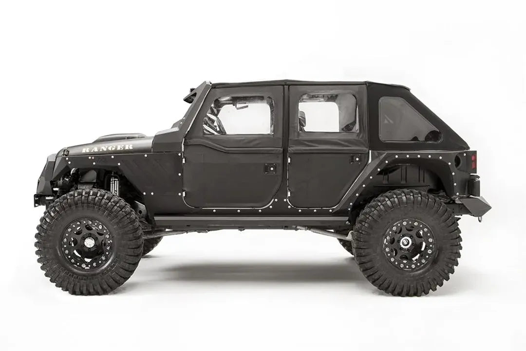 Fab Fours front and rear steel fenders on a lifted black Jeep Wrangler JK Unlimited, driver-side profile view