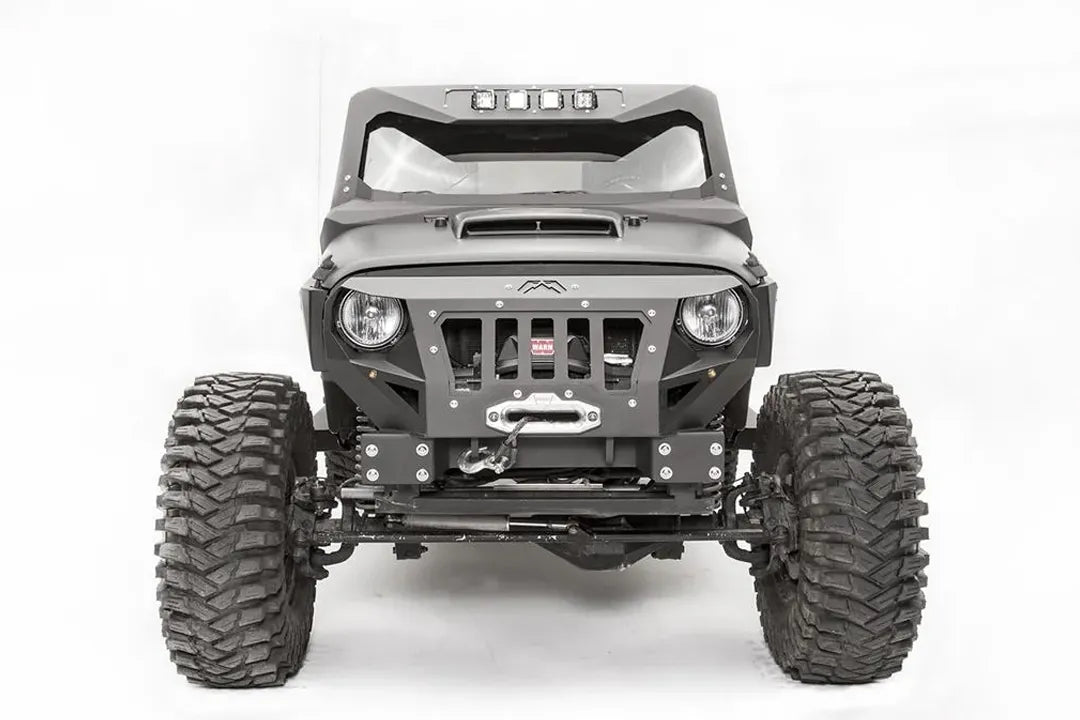 Fab Fours front steel fenders on a lifted black Jeep Wrangler JK, front view, with Fab Fours grille guard, winch, and cowl light bar