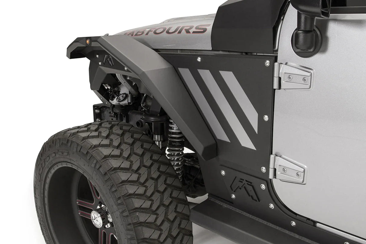 Fab Fours aggressive narrow front fender flare on a silver Jeep Wrangler JK, driver-side close-up, showing the faceted steel flare with marker light, inner fender liner and black side armor with the Fab Fours logo