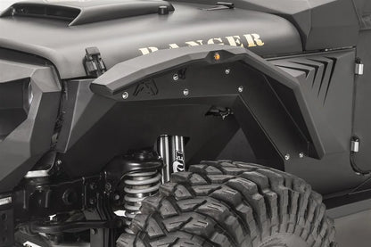 Close-up of Fab Fours fender gill box with angled vent slots behind the front fender flare on the driver side of a black Jeep Wrangler JK