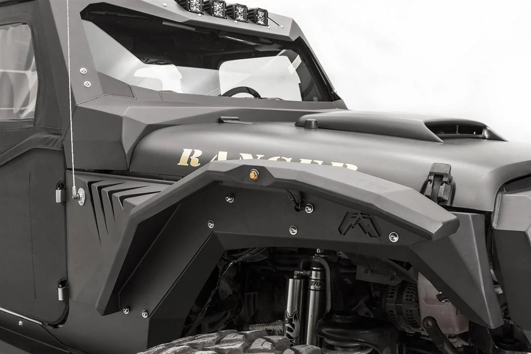 Close-up of Fab Fours fender gill box with angled vent slots behind the front fender flare on the passenger side of a black Jeep Wrangler JK