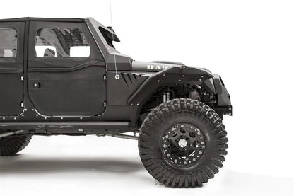 Fab Fours fender gill box behind the front fender flare on a lifted black Jeep Wrangler JK, passenger-side view of the front half