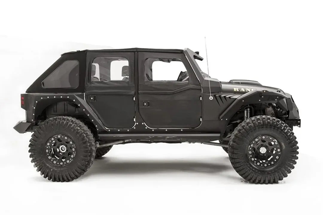 Fab Fours fender gill box behind the front fender flare on a lifted black Jeep Wrangler JK Unlimited, passenger-side profile view