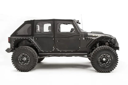 Fab Fours fender gill box behind the front fender flare on a lifted black Jeep Wrangler JK Unlimited, passenger-side profile view