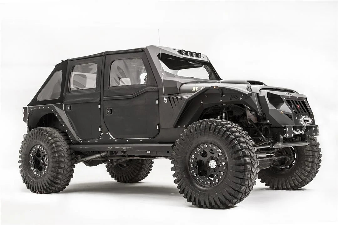 Fab Fours fender gill box and front fender flare on a lifted black Jeep Wrangler JK Unlimited, passenger-side front three-quarter view, with winch