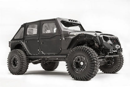 Fab Fours fender gill box and front fender flare on a lifted black Jeep Wrangler JK Unlimited, passenger-side front three-quarter view, with winch
