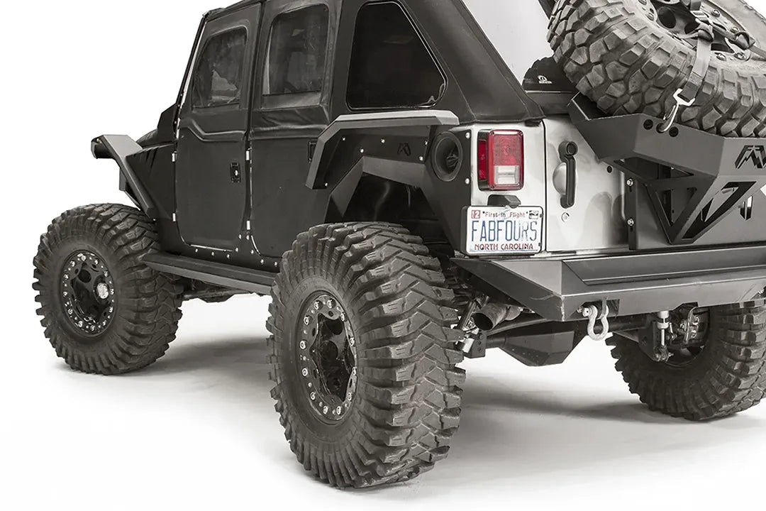 Fab Fours rear fender flare on a black 4-door Jeep Wrangler JK, close-up of the rear corner, showing the rear flare, riveted panel and wheel clearance