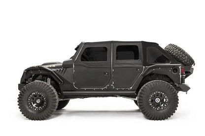 Fab Fours rear fender flare on a black 4-door Jeep Wrangler JK, driver-side profile view, showing the rear flare, wheel clearance and riveted body armor