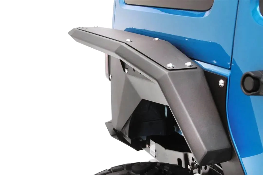 Fab Fours full-width rear fender flare on a blue Jeep, close-up of the rear wheel well, showing the riveted flare, inner fender liner and black powder coat finish