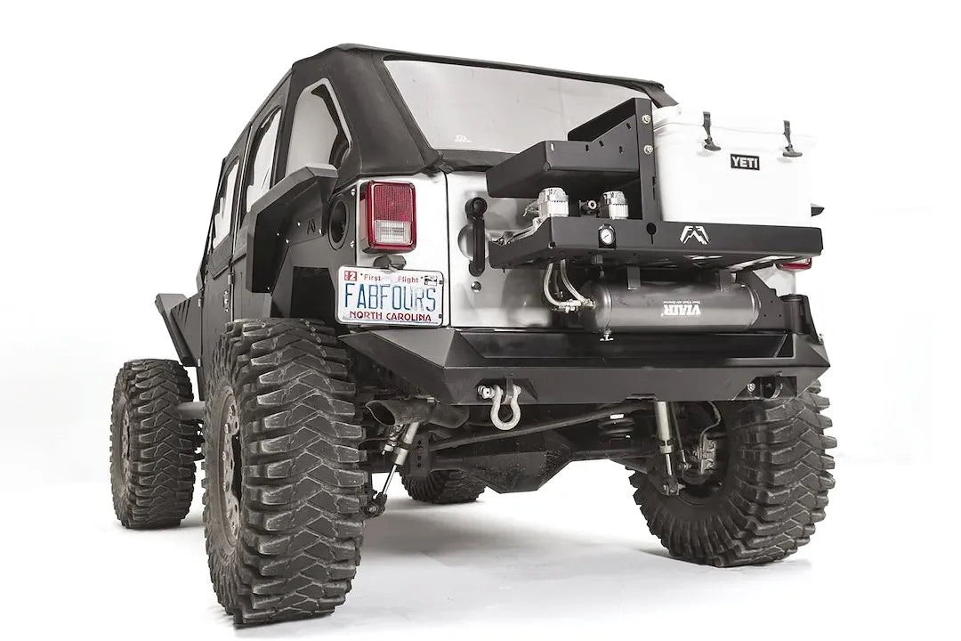 Fab Fours air compressor and cooler mount on a Jeep Wrangler JK, rear driver-side view, showing the dual Viair compressors, air tank and Yeti cooler on the tire carrier