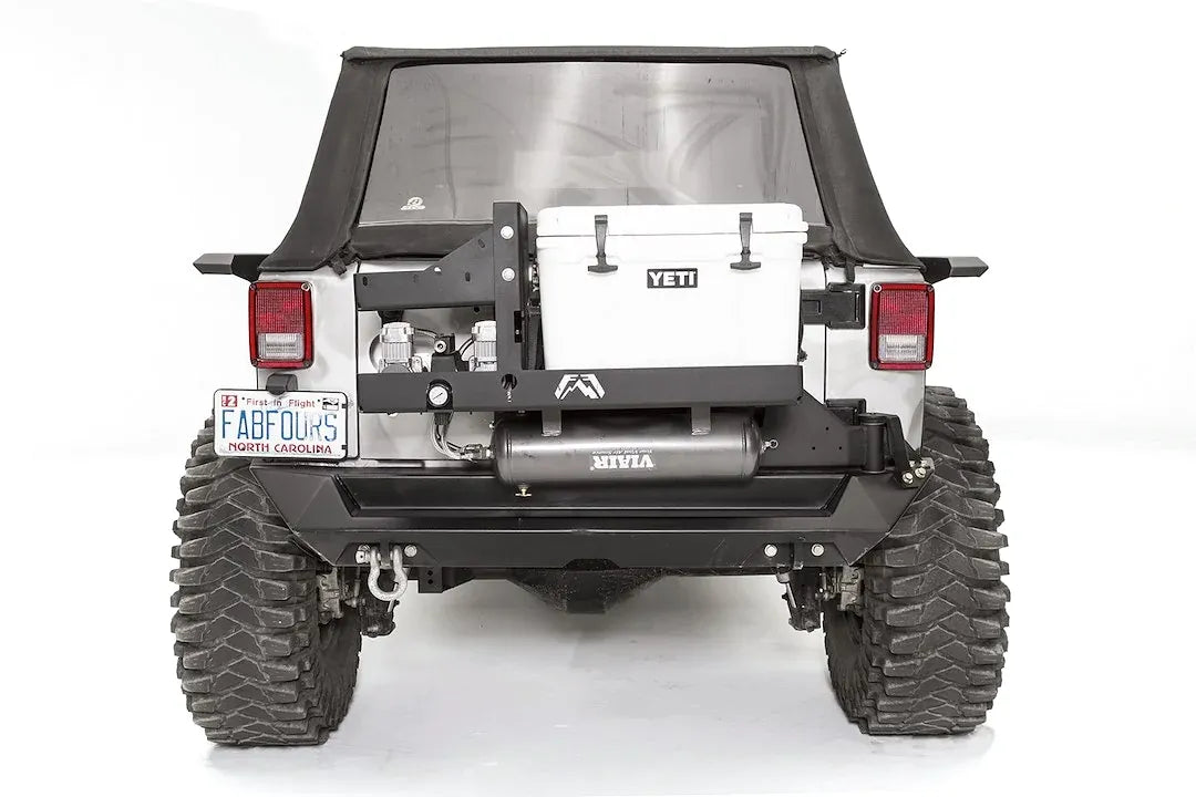 Fab Fours air compressor and Yeti cooler mount on a Jeep Wrangler JK, rear view, with dual Viair compressors beside the cooler and the air tank mounted below