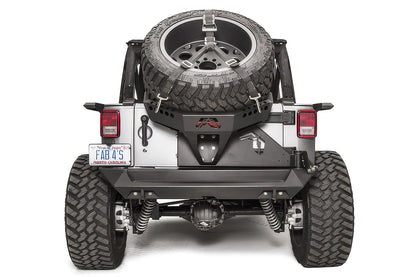 Fab Fours Slant Back Tire Carrier on a Jeep Wrangler JK, rear view, holding an oversized spare with ratchet straps above the rear bumper
