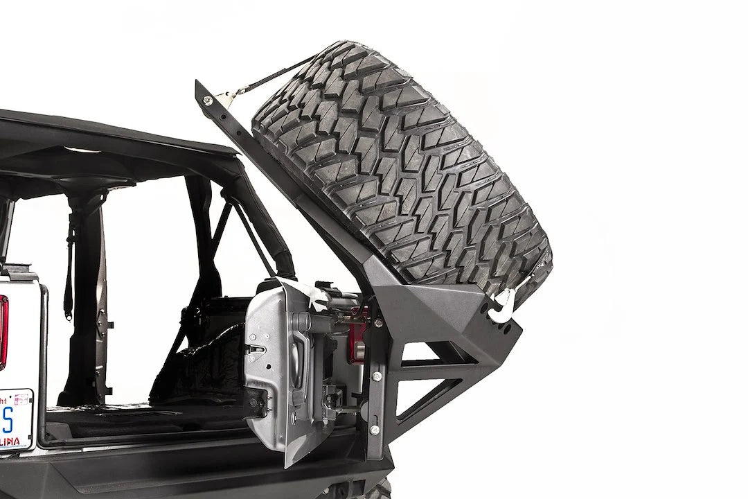 Fab Fours Slant Back Tire Carrier on a Jeep Wrangler JK, swung open with the tailgate for cargo access