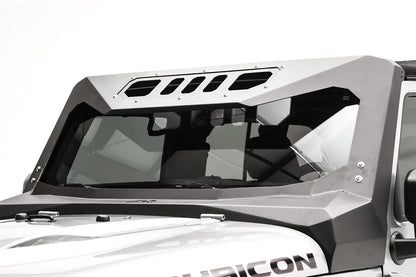 Close-up of the Fab Fours ViCowl on a silver Jeep Wrangler JK Rubicon, driver side, showing the formed steel A-pillar cover and slotted visor panel over the windshield