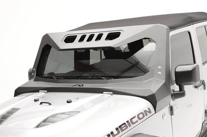 Fab Fours ViCowl on a silver Jeep Wrangler JK Rubicon with soft top, driver-side view, showing the matte black steel cowl wrapping the windshield and A-pillars