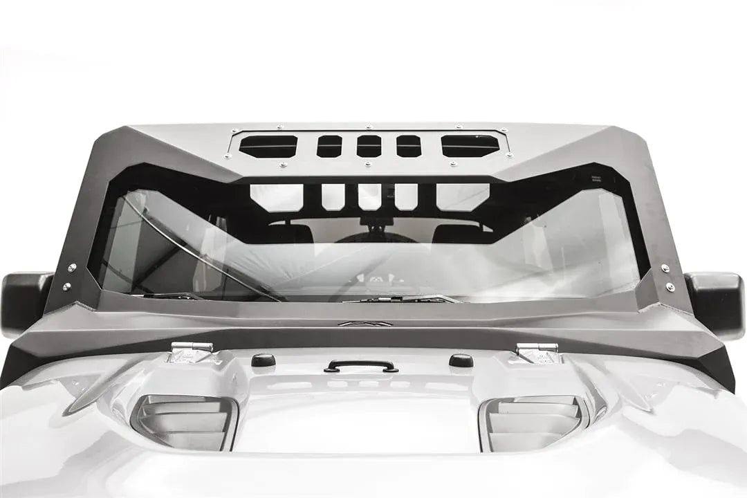 Fab Fours ViCowl on a Jeep Wrangler JK, front view over the hood, showing the full steel frame around the windshield with slotted visor cutouts and Fab Fours logo