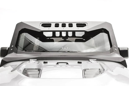 Fab Fours ViCowl on a Jeep Wrangler JK, front view over the hood, showing the full steel frame around the windshield with slotted visor cutouts and Fab Fours logo