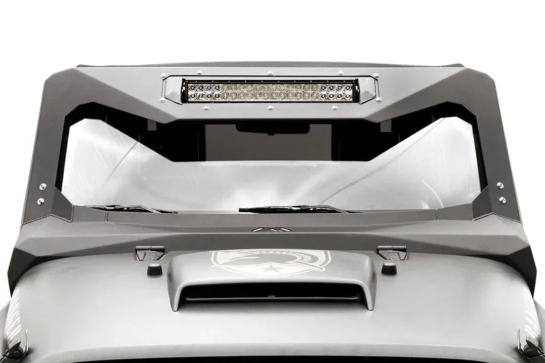 Fab Fours ViCowl Light Bar Insert Mount on a Jeep Wrangler JK, front view, showing a 20-inch LED light bar bolted into the insert across the top of the matte black steel windshield cowl