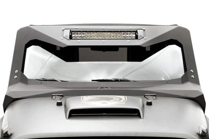 Fab Fours ViCowl Light Bar Insert Mount on a Jeep Wrangler JK, front view, showing a 20-inch LED light bar bolted into the insert across the top of the matte black steel windshield cowl