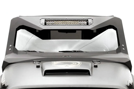 Fab Fours ViCowl Light Bar Insert Mount on a Jeep Wrangler JK, front view, showing a 20-inch LED light bar bolted into the insert across the top of the matte black steel windshield cowl