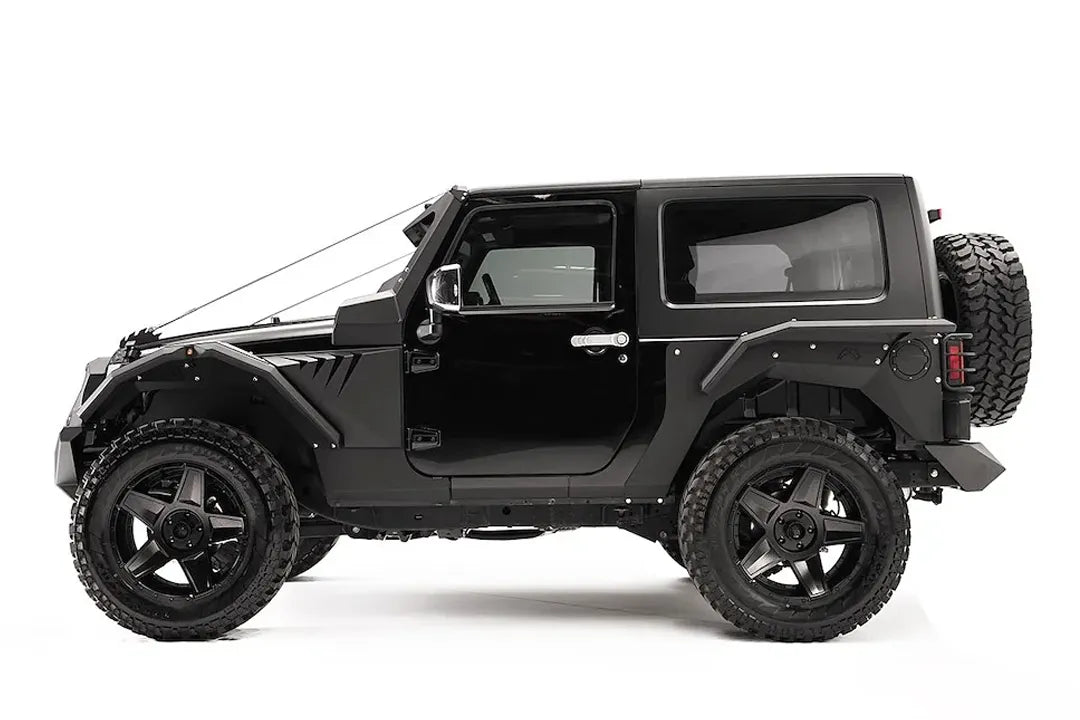 Fab Fours rear fender base on a dark gray 2-door Jeep Wrangler JK, driver-side profile view, showing the riveted rear fender panel and rear wheel clearance