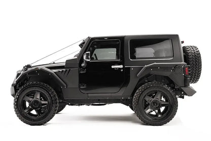 Fab Fours rear fender base on a dark gray 2-door Jeep Wrangler JK, driver-side profile view, showing the riveted rear fender panel and rear wheel clearance