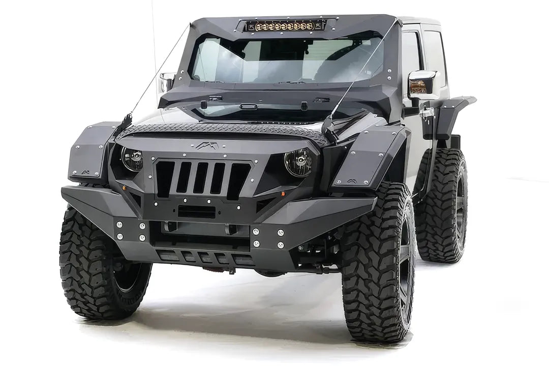 Fab Fours rear fender base on a dark gray 2-door Jeep Wrangler JK, driver-side front three-quarter view, showing the riveted fender armor and full Fab Fours body kit