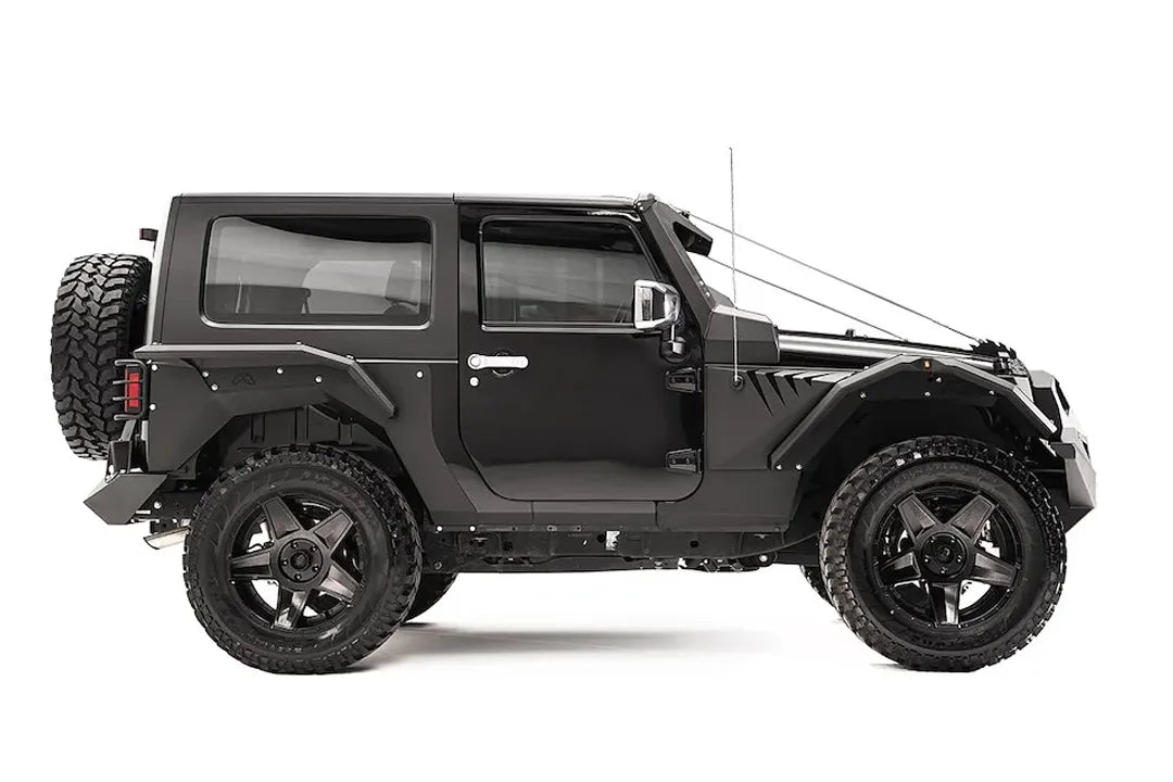 Fab Fours rear fender base on a dark gray 2-door Jeep Wrangler JK, passenger-side profile view, showing the riveted rear fender panel and rear wheel clearance