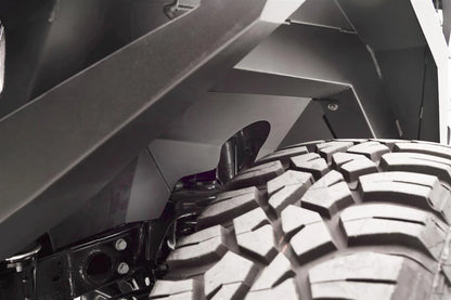 Close-up of Fab Fours front inner fender liner above the tire and shock on a Jeep Wrangler JL