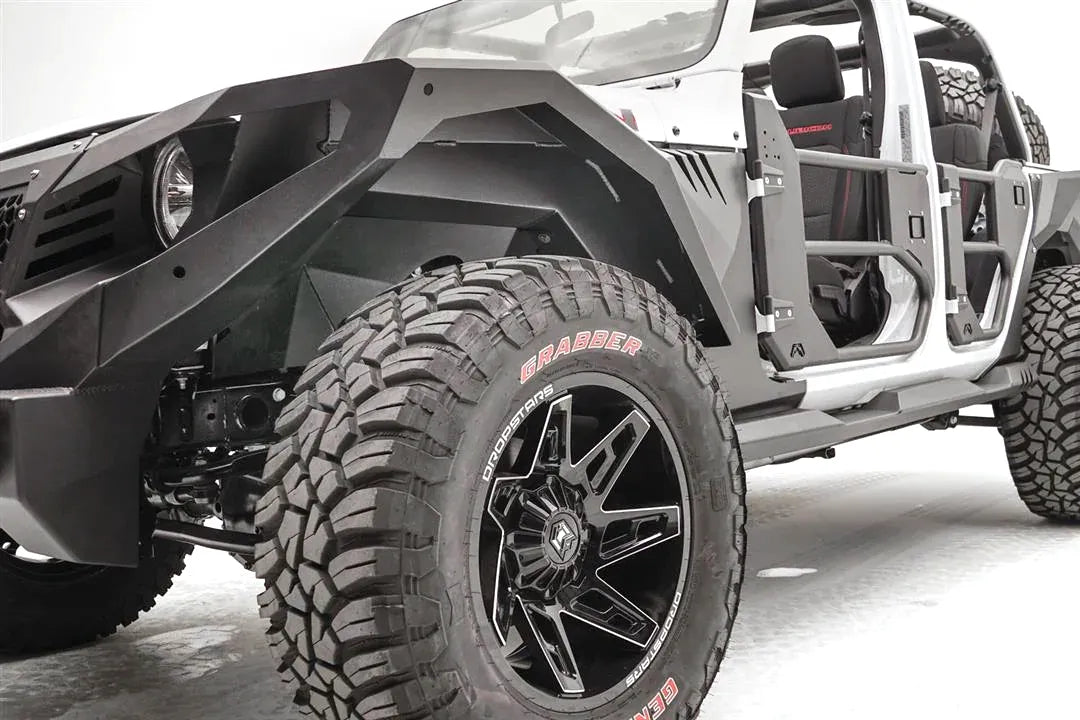 Fab Fours front inner fender and fender flare on a lifted white Jeep Wrangler JL with tube doors, driver-side front three-quarter view, with Fab Fours winch bumper