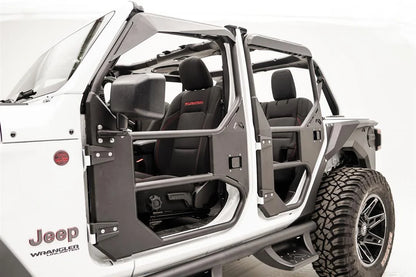 Fab Fours full tube doors on a white Jeep Wrangler JL Unlimited, angled driver-side close-up, showing the front door with mirror mount, factory hinges, paddle latch and padded upper frame